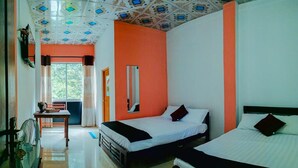 A room with two beds, a desk, a chair, and a fan. - Dewy Arena Hotel (Ella)