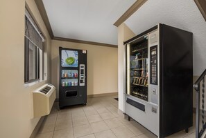 A vending machine area with a beverage dispenser and a refrigerated section, both with clear signage and selection options. - Red Roof Inn & Suites Vineland - Buena (Buena)
