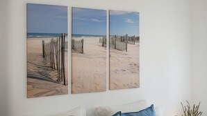 A room with a bed, a nightstand, and a wall-mounted artwork depicting a beach scene. - Bright Albufeira - 5min to the beach by LovelyStay (Albufeira)