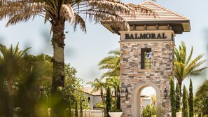 Enter the charming Balmoral through a traditional stone archway, surrounded by lush greenery.