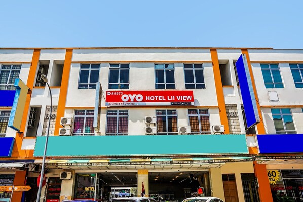 A hotel building with a prominent red sign for OYO HOTEL LII VIEW.