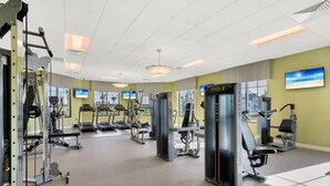 A gym with various exercise machines, treadmills, and weightlifting equipment.