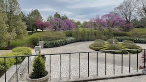 A landscaped garden with a paved walkway, stone steps, and various shrubs and trees. - 13,000 sq. ft. 6BR Estate on 5 acres Swim Spa, Hot Tub, Pool Table, Game Room (Muncie)