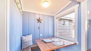 A room with a wooden table, a bench, a star decoration, and a window with blinds.