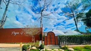 A building entrance with a sign reading "Papa Q." - papa q suite resorts (Roi Et)