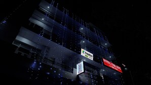 A building with multiple floors, illuminated by numerous small lights. There are signs for 'Treebo' and 'Hotel The King'. - Treebo The King Mohali (Mohali)