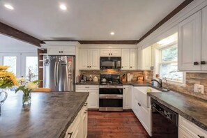 Enjoy cooking in this well-equipped kitchen with stainless steel appliances and ample countertop space.