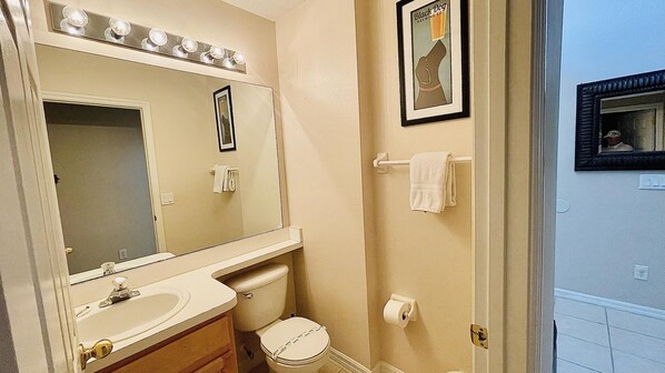 A bathroom with a sink, mirror, toilet, and towel rack. - Highlands Reserve 3 Bed Pool Home with Spa, Spacious Living & Close to Disney (Davenport)