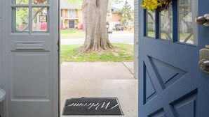 A blue door with a doormat reading "Welcome". - Beautiful Spacious Home- Near the Expo, TU, gathering Place, Fair park (Tulsa)