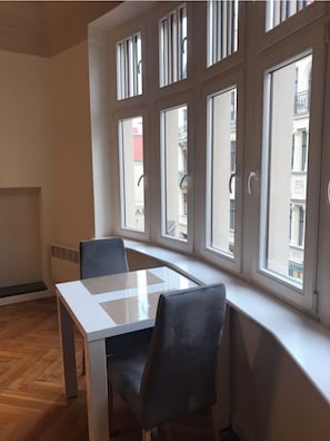 Enjoy a view of the street from the large window with multiple panes, paired with a simple, clean room design.