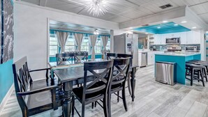 A modern kitchen with a central island, stainless steel appliances, and a view to the dining area. - Turquoise Turtle - Private Heated Pool: Relax & Enjoy (Fort Pierce)