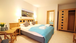 A neatly arranged bedroom with a bed, bedside table, chair, and a wardrobe. - Aparthotel Alte Schmiede Dettelbach  (Dettelbach)
