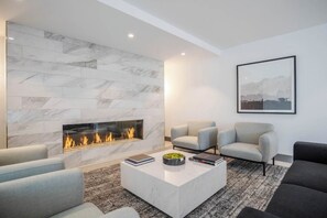 Cozy living room with a fireplace, comfortable sofa, and a space for relaxation.