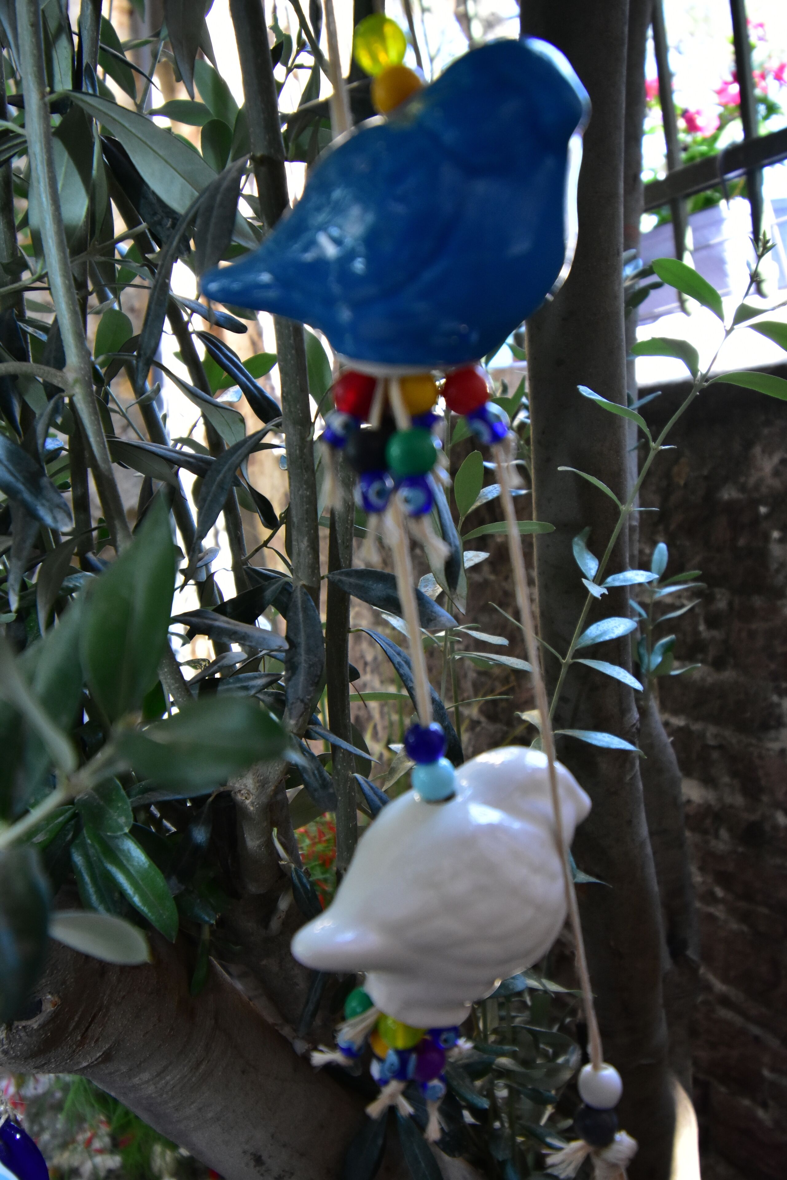 A bird-shaped decoration hanging from a tree branch.