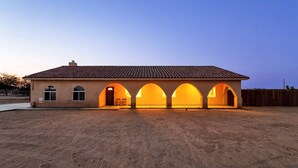 A building with a tiled roof and multiple arched openings.