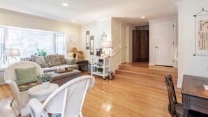 A spacious living room with a sofa, chairs, and a coffee table. There is a staircase leading to another room. - Bright Garden Guest Suite in Los Gatos, Heart of Silicon Valley (Los Gatos)