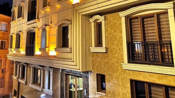 A multi-story building with classical architecture, featuring balconies with wrought iron railings and warm interior lighting. - The Canka Hotel Residance Istanbul (Istanbul)