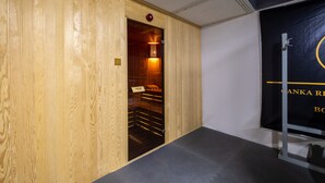 A wooden panel wall with a door leading to a room with a black floor and a black wall with gold lettering. - The Canka Hotel Residance Istanbul (Istanbul)