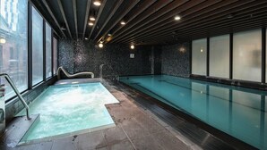 A spa area with a hot tub and a swimming pool, large windows, and a modern ceiling design. - Lovely City Escape 2B2B Unit in Melbourne Central (Melbourne)