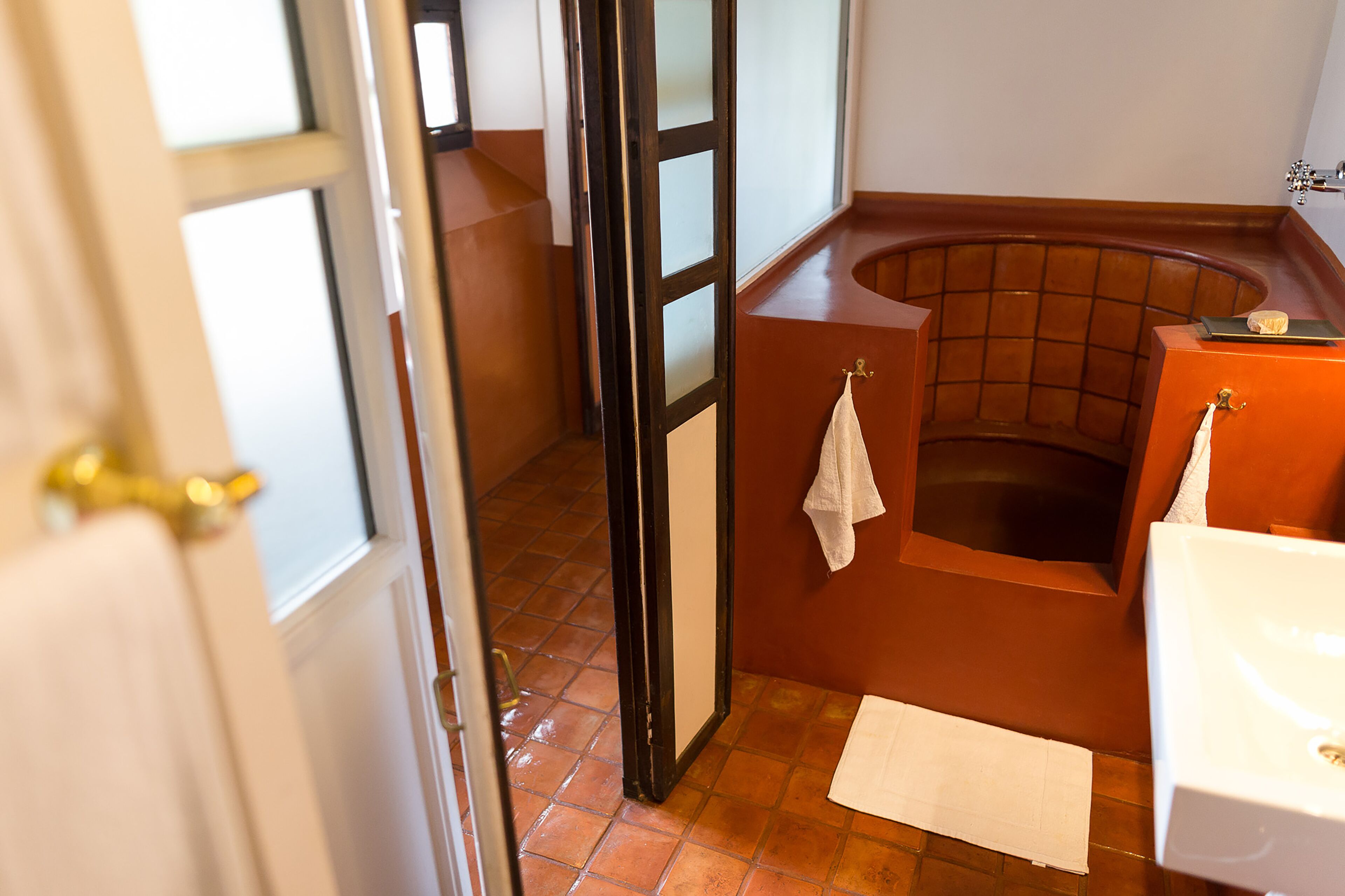 A bathroom with a bathtub, a toilet, and a sink.