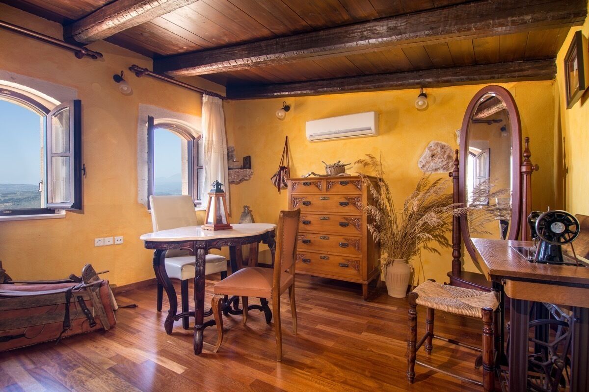 A rustic room with wooden furniture, a vintage sewing machine, and a large mirror.