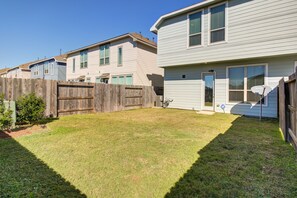 A residential area with houses, a wooden fence, and a grassy yard. - Meticulously-maintained 3-BR Home w/ Backyard - Double Story (Booth)