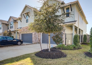 A residential building with a garage, a driveway, and a tree in the front yard. - Meticulously-maintained 3-BR Home w/ Backyard - Double Story (Booth)