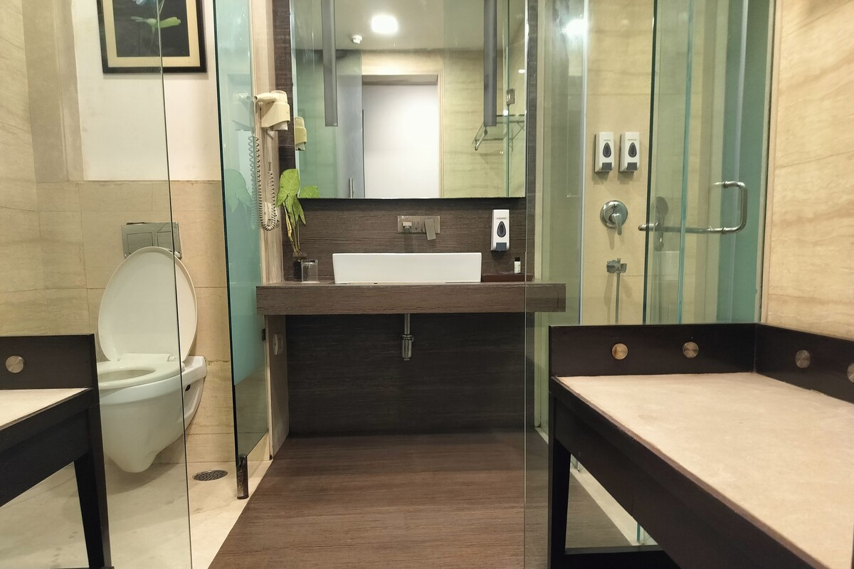 A modern bathroom with a toilet, sink, and shower area.