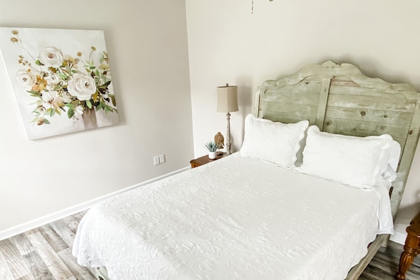 First bedroom with queen size bed and smart TV