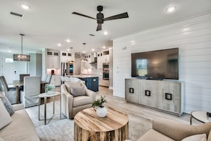 A modern living room with a TV, sofa, and coffee table. - R3 at Lake Powell/Inlet Beach with EV charger (Panama City Beach)
