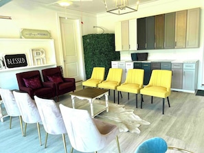 A modern living room with a dining area, a kitchen, and a green wall. - R3 at Lake Powell/Inlet Beach with EV charger (Panama City Beach)