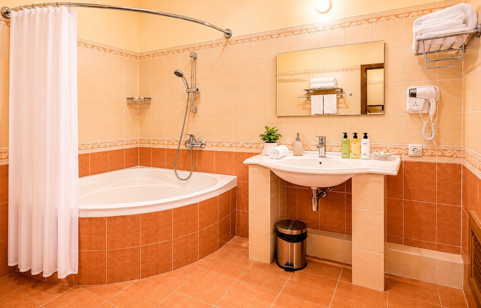 A bathroom with a bathtub, a sink, a mirror, a towel rack, and a trash can.