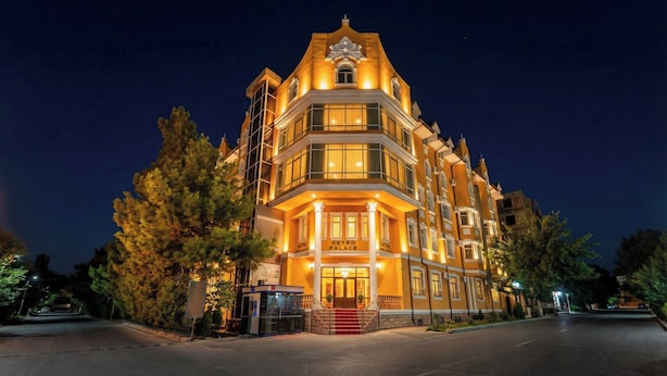A multi-story building with a prominent entrance, large windows, and a sign reading "RETRO PALACE." - RETRO PALACE (Tashkent)