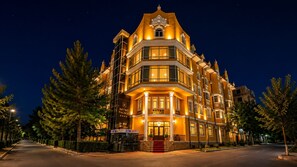 A multi-story hotel with a classic architectural design, featuring a prominent entrance with a staircase, and an ATM on the ground floor. - RETRO PALACE (Tashkent)