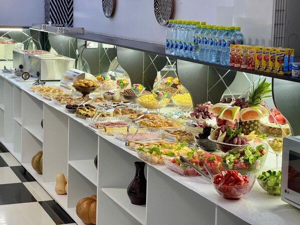 A buffet with various food items and beverages. - RETRO PALACE (Tashkent)