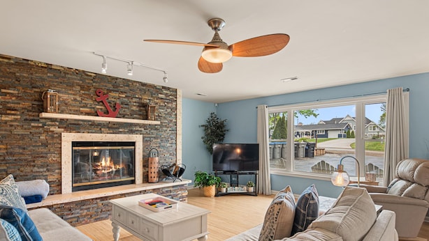 A living room with a fireplace, television, and comfortable seating.