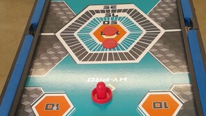 A table hockey game with a blue and orange design, featuring the HY-PRO logo. - Synod Cottage | Private Hot Tub, Dog Friendly, Near New Quay (Ceredigion)
