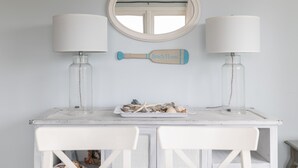 A white vanity table with two lamps, a mirror, and a decorative item labeled "Beach House". - Carolina House - Steps to Beach, Fantastic Location!  Walk to All Attractions (Emerald Isle)