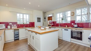 A modern kitchen with white cabinets, a wooden countertop, and a built-in oven. - 6 bedroom accommodation in Beauly, near Inverness (Beauly, near Inverness)