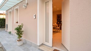A house with a covered patio, a potted plant, and a door leading to a dining area. - 2 bedroom stunning home in Camaiore (Camaiore)