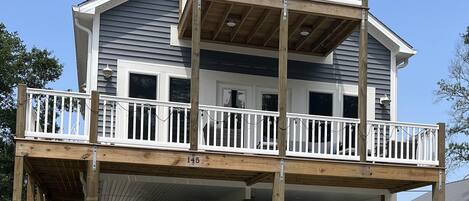 A two-story house with a balcony and a garage.