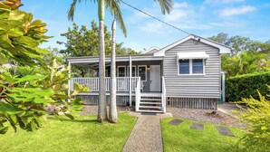 A single-story house with a porch, a front door, and a small deck. - Driftwood Mudjimba-Beach Holiday (Sunshine Coast)