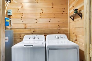 A laundry room with two white front-loading washers and a blue water heater. - *Pet Friendly *MtnViews *HotTub*Game Room*Fire pit (Sevierville)