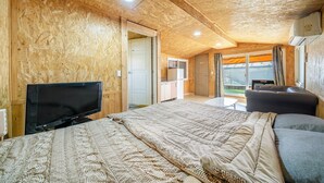 A cozy room with a bed, a TV, a small table, and a sofa. - Gapyeong Ilekaempingjang (Gapyeong)
