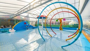 An indoor water park with slides, a wave pool, and colorful play structures. - Gapyeong Ilekaempingjang (Gapyeong)