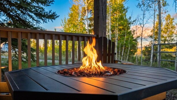 A square outdoor fire pit with a metal frame and a central fire burning. - Remodeled Granby Ranch Condo - 20 miles to RMNP w/ Hot Tub & Firepit (Granby)
