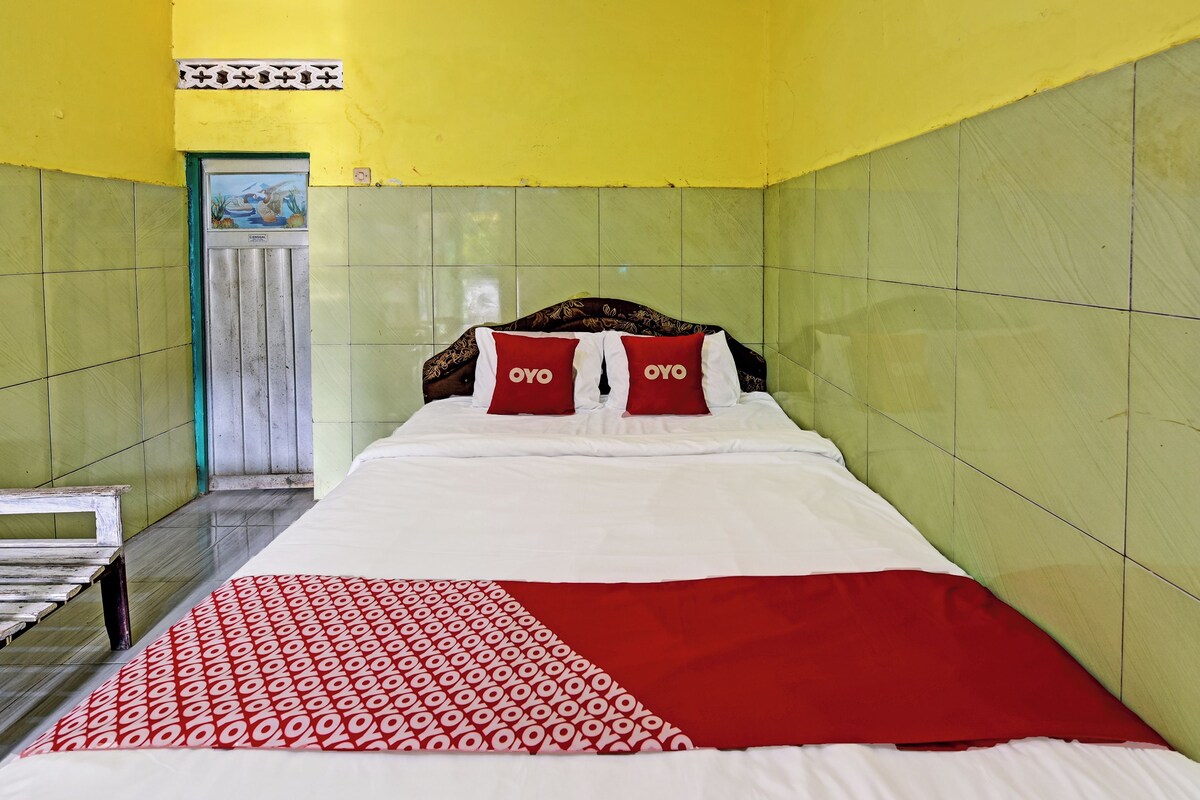 Ein Hotelzimmer mit einem Bett, einer Bank und einer Tür.
