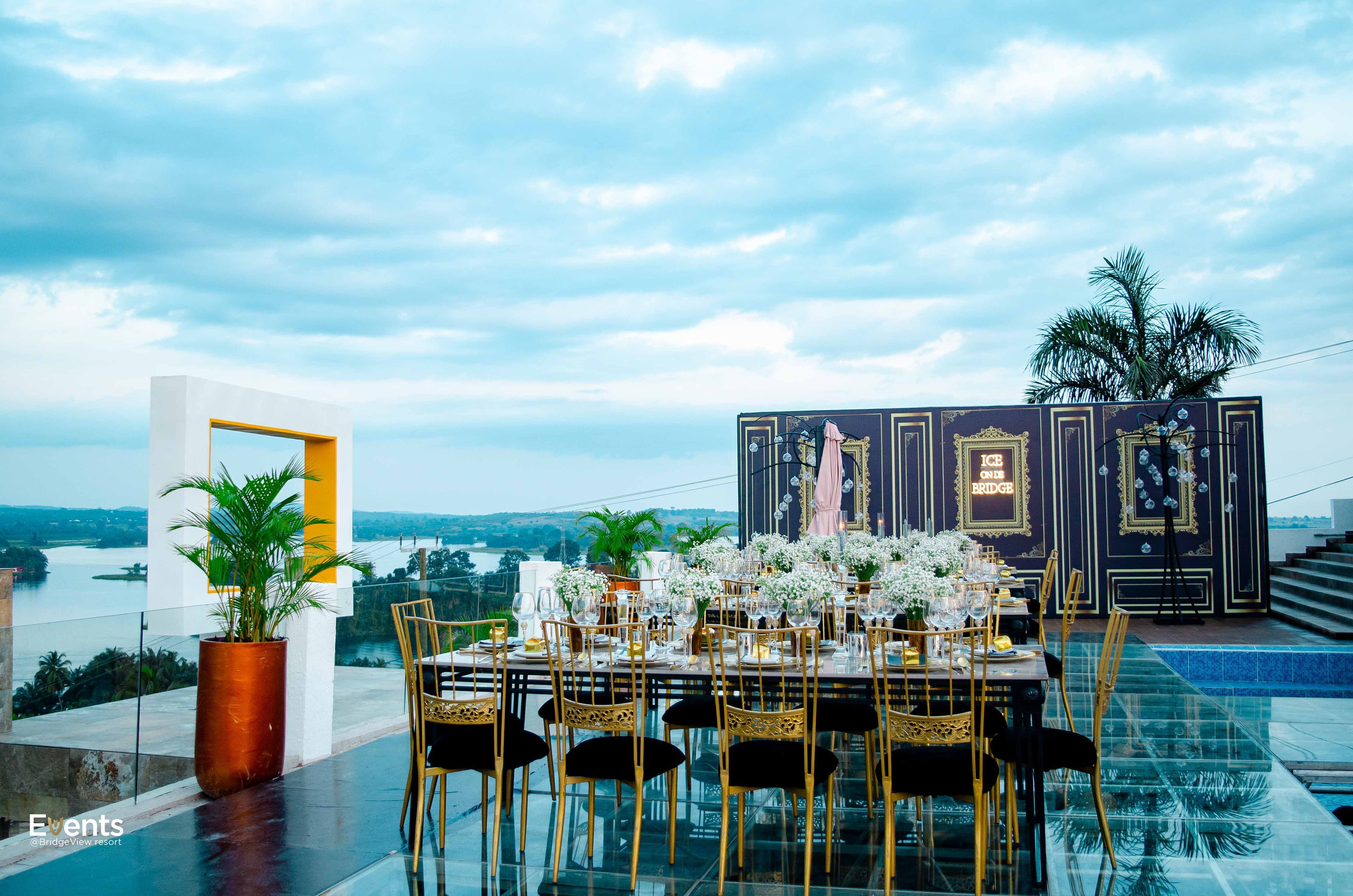 A dining area with a table set for six, overlooking a scenic view.