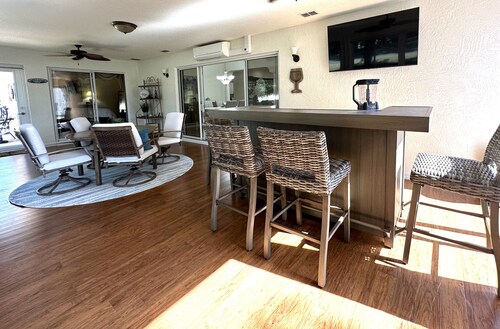 Great location..Climate-controlled lanai & NEW 2024 4-SEATER GOLF CART INCLUDED!