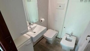 A compact bathroom with a sink, toilet, and bidet. - Beautiful apartment with excellent location (Buenos Aires)